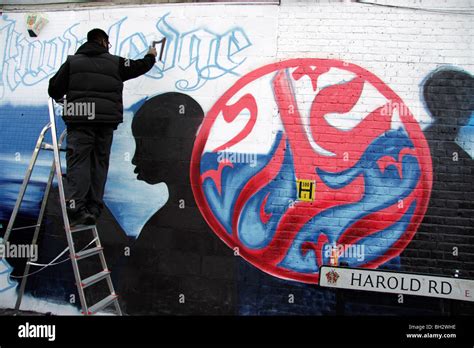 Graffiti Artist Mohammed Ali Spray Painting A Mural Onto A Wall In