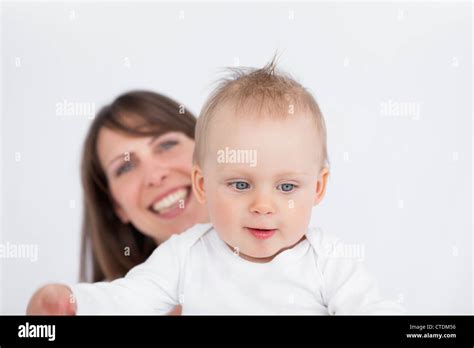 Smiling Brunette Woman Holding Her Cute Baby Stock Photo Alamy