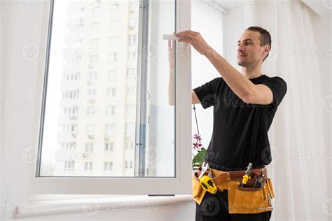 Young worker checking window after repair 45742913 Stock Photo at Vecteezy