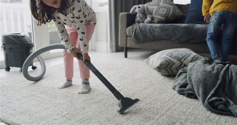 Girls Children Cleaning And Vacuum Carpet In Living Room Hygiene And