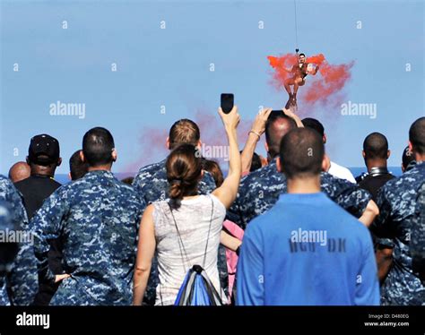 A helicopter owers a rescue swimmer Stock Photo - Alamy