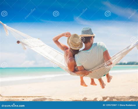 Young Couple In Love Relaxing In A Hammock By The Beach Stock Image