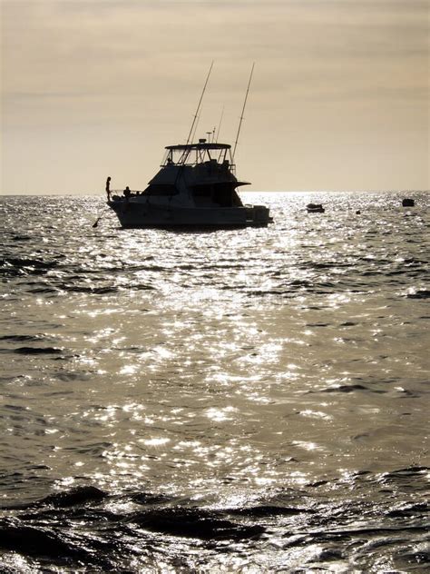 Boat Silhouette at Sunset stock image. Image of water - 171743159