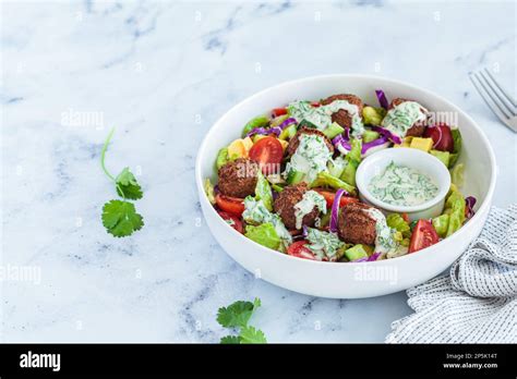 Falafel Salad With Avocado Tomato And Tahini Dressing Israeli