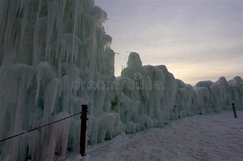 A Wall Made Out of Frozen Blocks of Ice and Icicles Towering Against ...