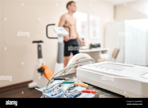 Clothespins Of The Ecg Machine In The Foreground Athlete Does A