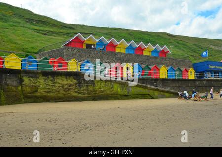 Multi-coloured beach huts at Whitby Beach, Whitby, Yorkshire, England, UK Stock Photo - Alamy