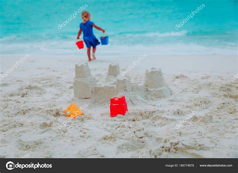 Little girl building sand castle on beach Stock Photo by ©Nadezhda1906 ...