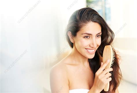 Smiling Brunette Woman Brushing Hair Stock Image F017 1571