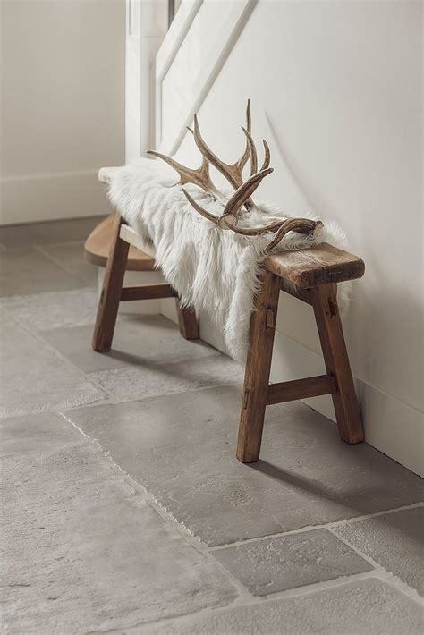 A Bench With Antlers On It Sitting In Front Of A White Wall And Door