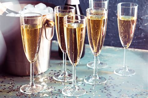 Premium Photo Champagne Bottle In Bucket With Ice And Glasses Of