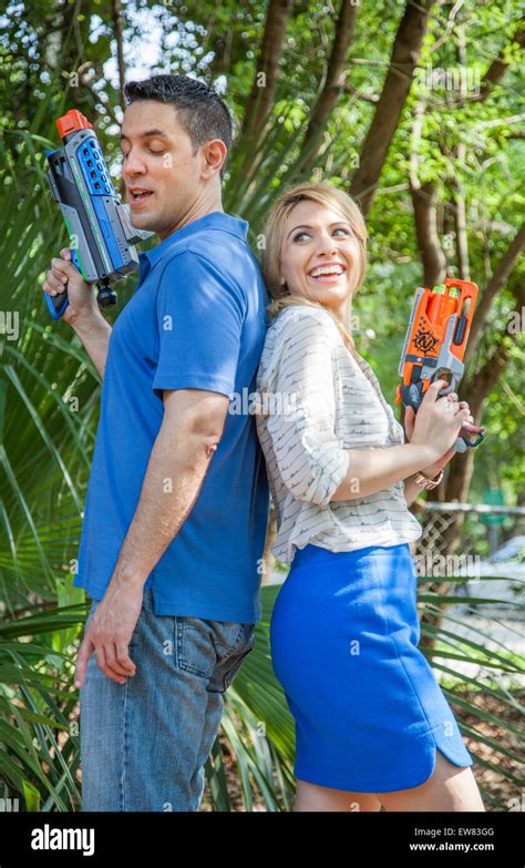 Young Couple Playing With Nerf Guns In Park In Florida Stock Photo Alamy