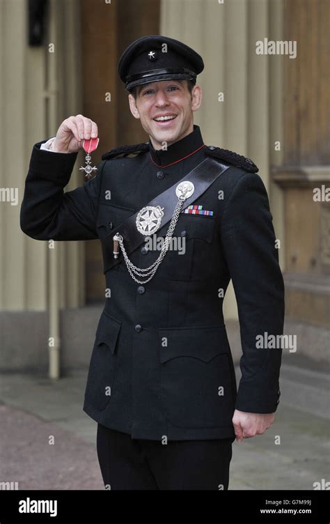 Major David Pack Of The Royal Gurkha Rifles Holds His Member Of The