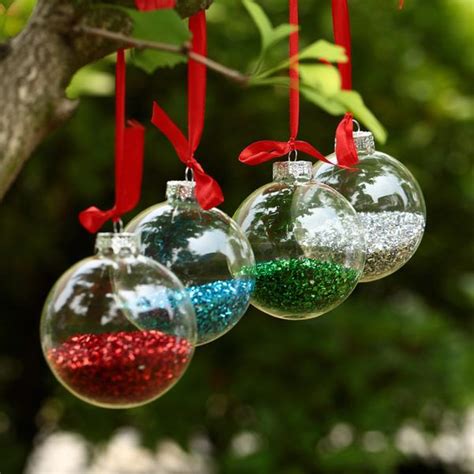 Three Glass Ornaments Hanging From A Tree