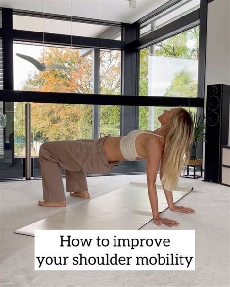 A Woman Is Doing Exercises On The Floor In Front Of A Large Window With