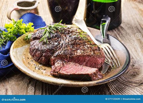 Barbecue Aged Angus Rib Eye Beef Steak With Salt And Pepper On A Rustic