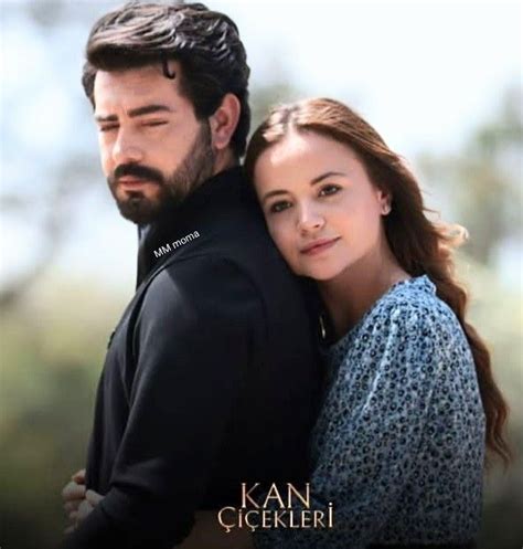 A Man And Woman Embracing Each Other In The Middle Of An Outdoor Photo