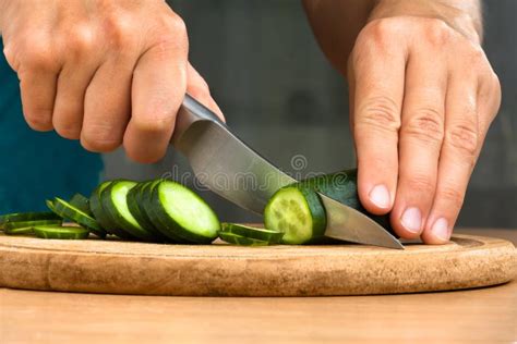 Hands Slicing Cucumber On The Cutting Board Stock Photo Image Of