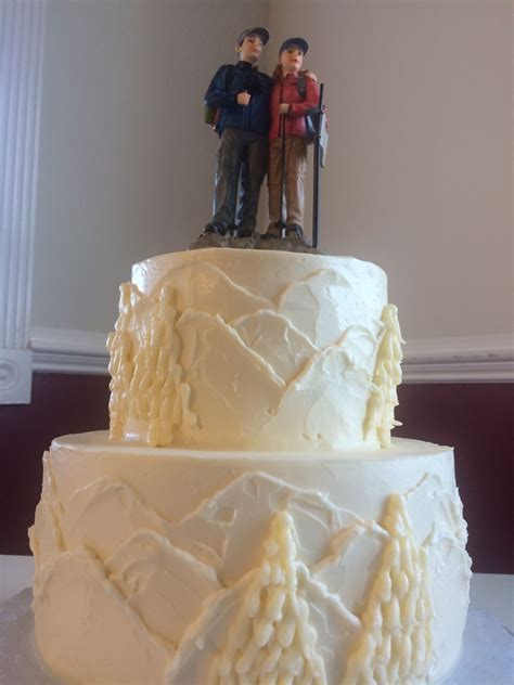 Simple Tiered Rustic Cake With White Mountain Detailing And Hiker Cake