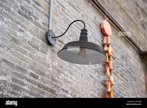 Outdoor Street Lamp Installed On Stone Wall Of Ancient Chinese Building