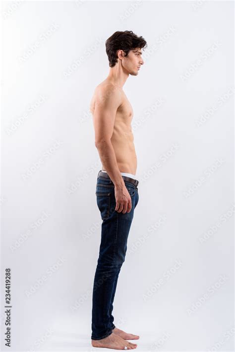 Full Body Shot Of Profile View Of Young Handsome Man Standing Sh Stock