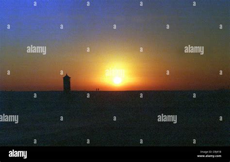 Sunset at Lighthouse Pilsum Stock Photo - Alamy