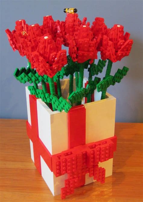 A Vase With Red Flowers In It Sitting On A Table