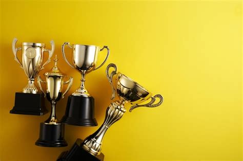 Premium Photo | Gold trophy against yellow background