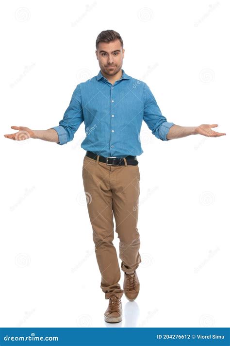 Casual Man Walking Towards The Camera With Opened Arms Stock Photo