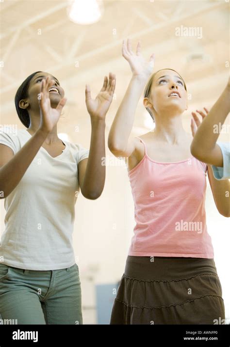 Teenage Girls Holding Arms Up To Hit Ball Stock Photo Alamy