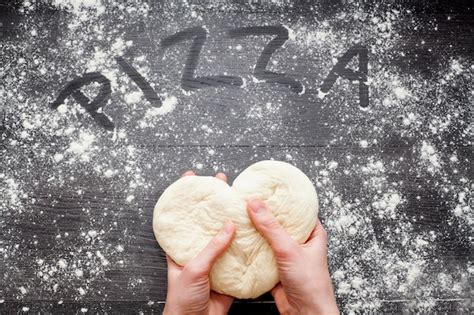 Premium Photo Hands Kneading The Dough On A Table