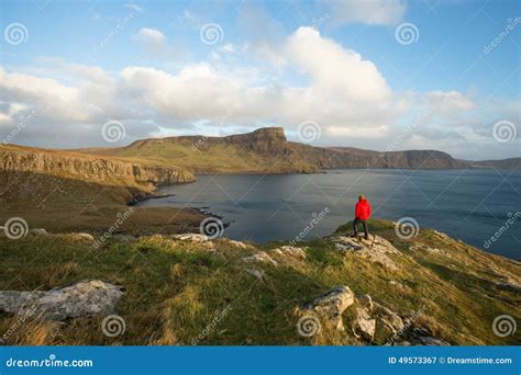 Man Hiking Through Scottish Highlands Along Rugged Coastline Stock