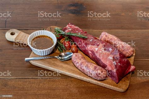 Argentine Cut Of Meat Called Vacio With Chorizos And Chimichurri Stock