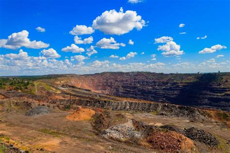 Huge Iron Ore Quarry With Working Dump Trucks And Excavators In Kryvyi