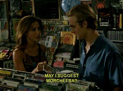 A Man Standing Next To A Woman In Front Of A Record Store Filled With Cds