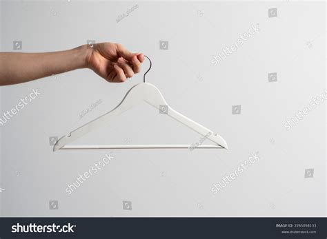 hand holding empty cloth hanger stock photo  shutterstock