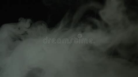 White Thick Clouds Of Smoke On A Black Background In Slow Motion Stock