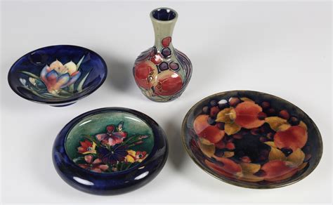 Four pieces of Moorcroft pottery, comprising a Pomegranate pattern ...