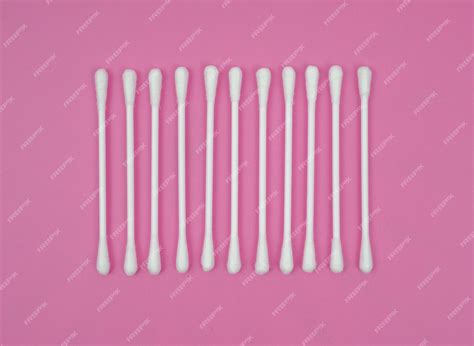 Premium Photo | Ear sticks cotton on pink background