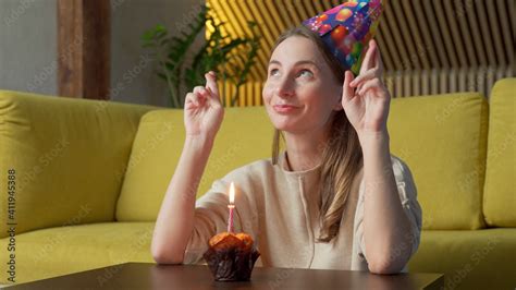 Woman Makes A Wish Blows Out The Candles On A Birthday Cake And Laughs