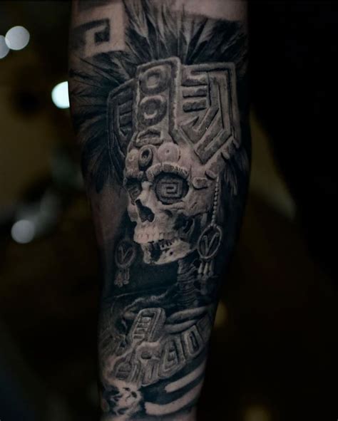 A Man S Arm With A Skull And Headdress Tattoo Design On It