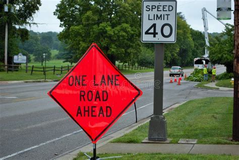 One Lane Road Ahead Construction Sign On The Side Of A Five Lane Road