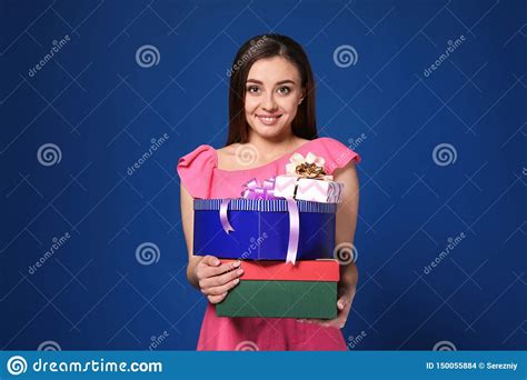 Mujer Joven Hermosa Con Las Cajas De Regalo En Fondo Del Color Foto De