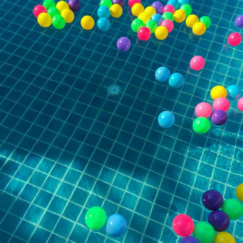 Assorted Color Balls Floating On Water · Free Stock Photo