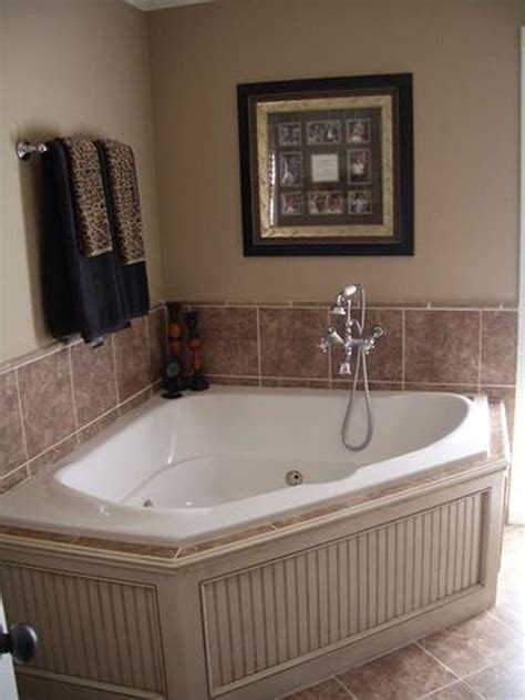 A Bathroom With A Large Bathtub In The Middle Of It And Towels Hanging