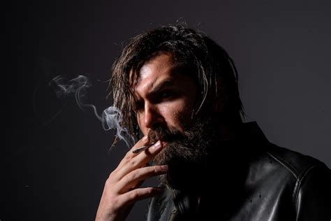 Premium Photo | Portrait of handsome man with cigarette bearded man smoking cigarette smoke ...