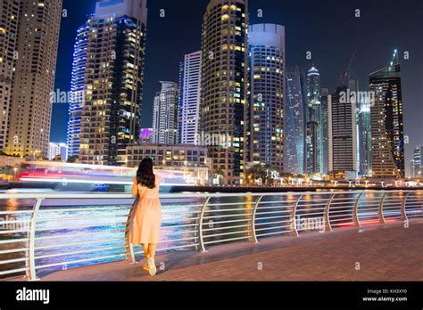 Girl enjoying Dubai marina modern skyscrapers view at night Stock Photo ...