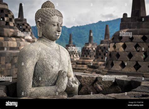 Ancient Buddha statue at Borobudur temple in Yogyakarta, Java ...