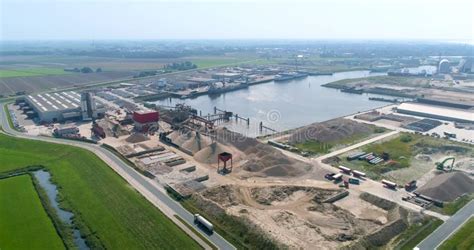 Harlingen Industrial Port With Factory And Sand Piles Following Truck