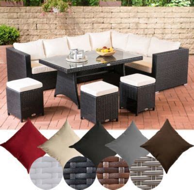 An Outdoor Patio Furniture Set With Cushions And Tables